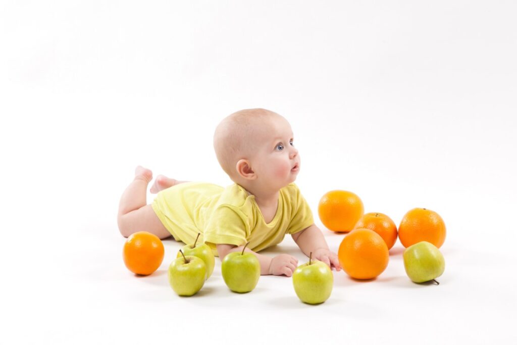 cute-smiling-healthy-child-lies-white-background-among-frui