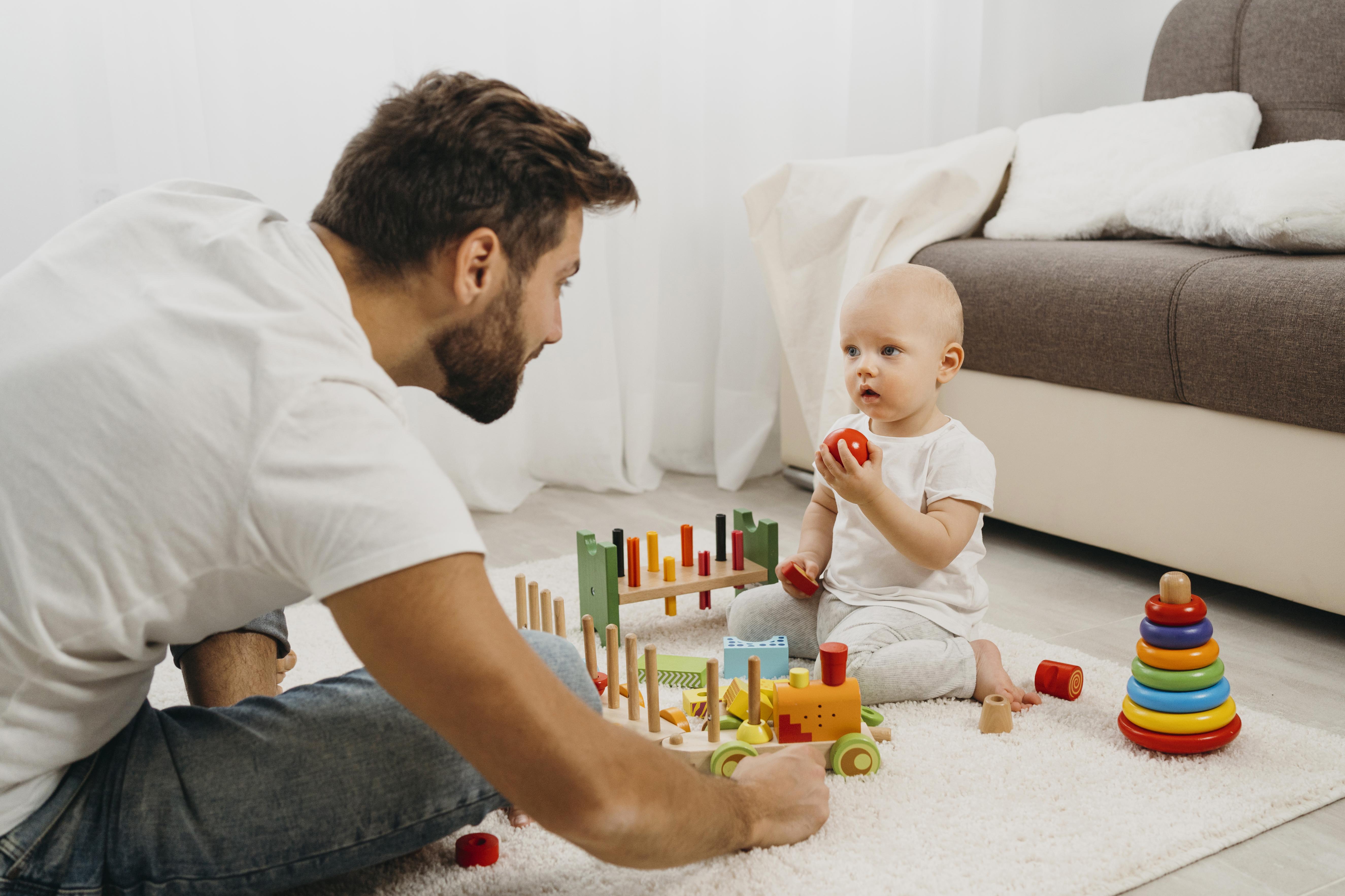 father-teaching-baby-play-with-toys