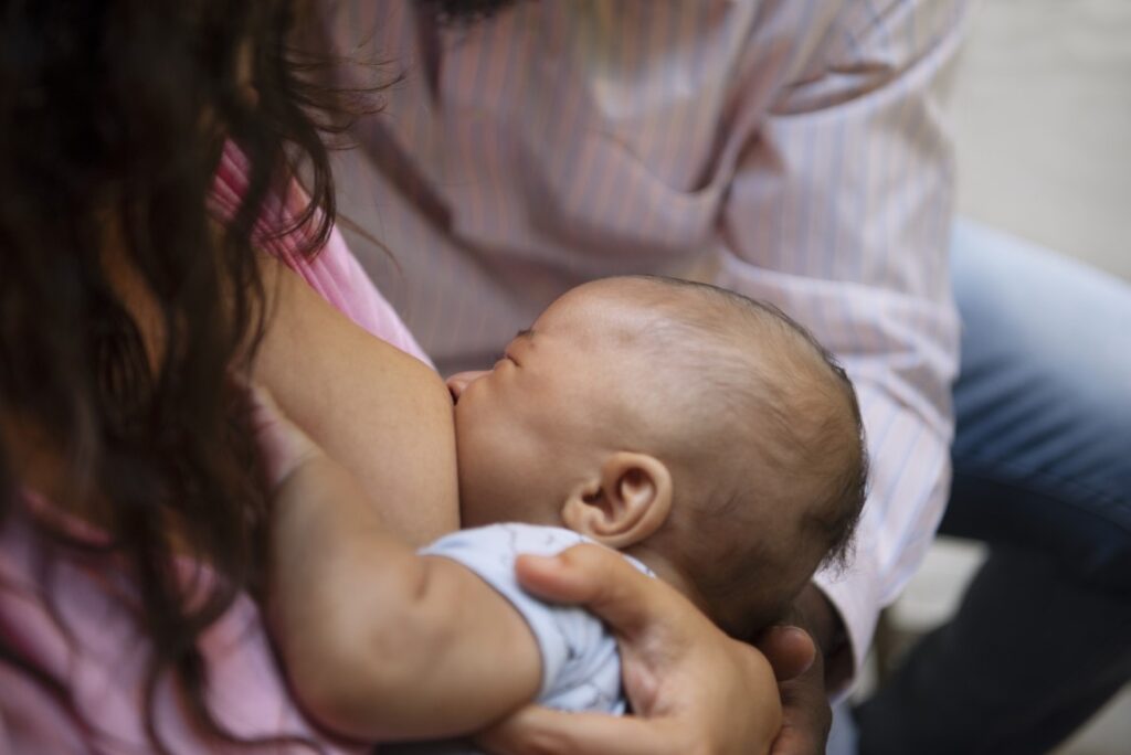 high-angle-woman-breastfeeding