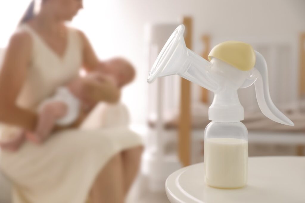 mother-little-baby-indoors-focus-table-with-breast-pump