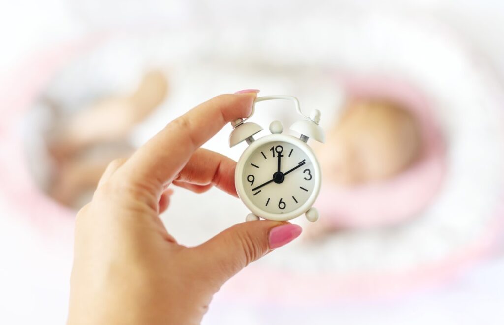 newborn-baby-alarm-clock-selective-focus-people