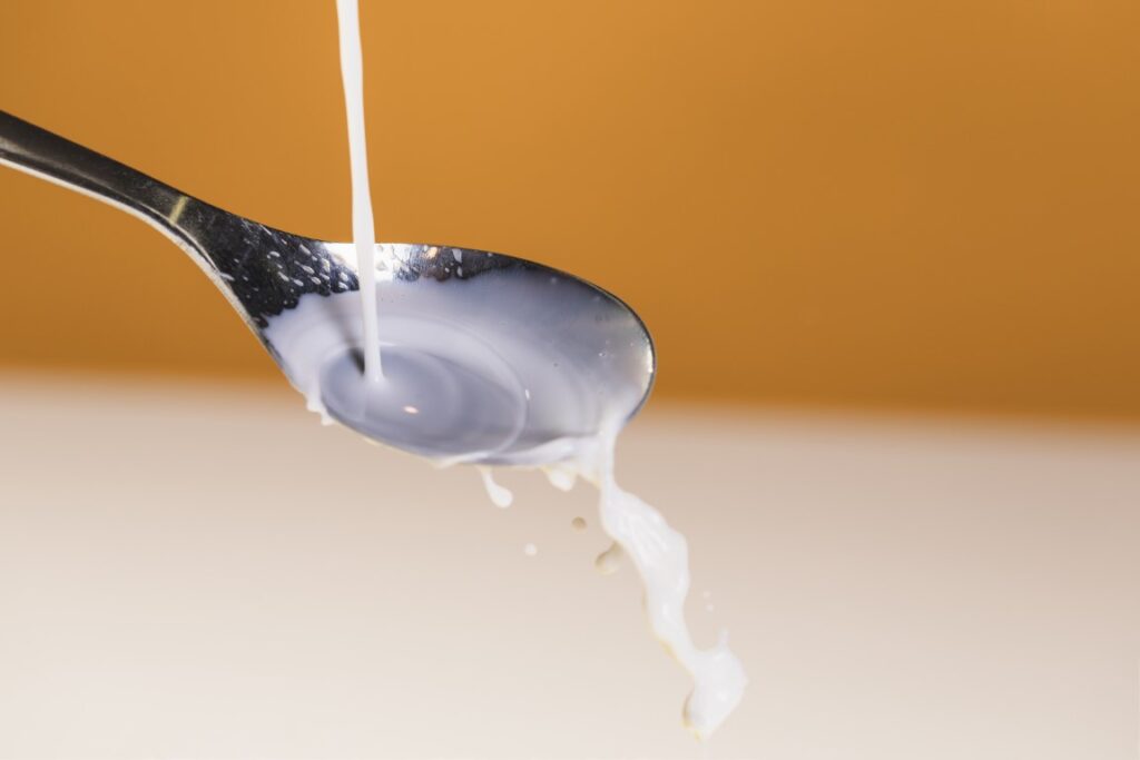 pouring-organic-milk-spoon
