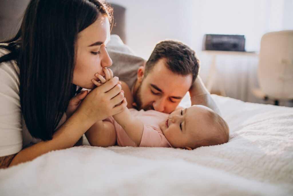 young-family-with-baby-daughter-lying-together-bed